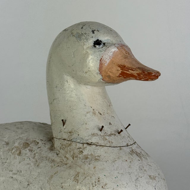An adorable vintage early 20th Century hand carved duck. Old pearly white paint adorns its body with a sweet pink-peach...