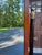 Biedermeier style (mid-20th Century) cheval mirror with beveled arched glass inset within a walnut veneer frame. This...