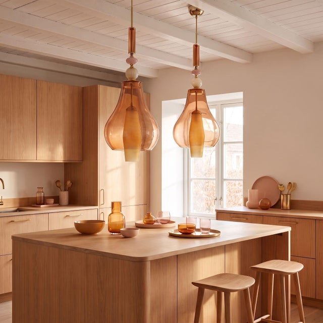 Pair of Murano glass Mid-Century Modern pendant lights, Italy circa 1990s. The Italian chandeliers are made of salmon...