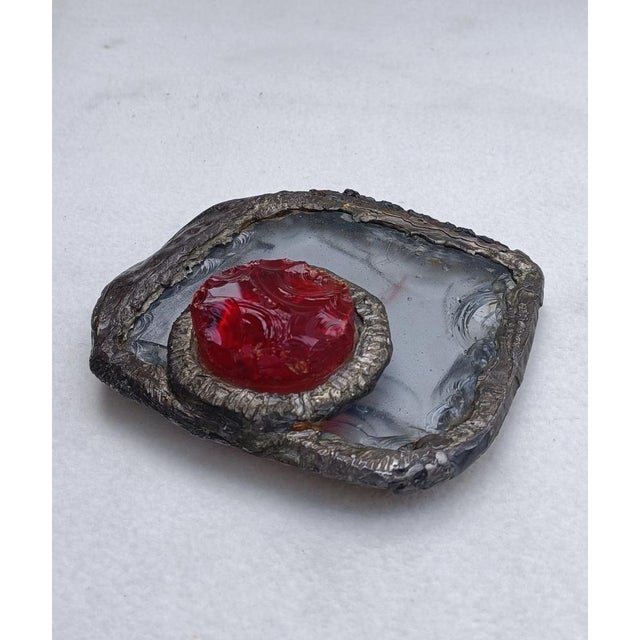 A highly decorative Brutalist object in hammered red and clear glass encased in a tin casting. Typical Italian...