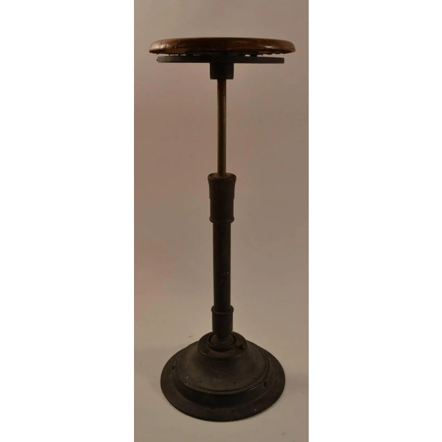 Wood seat, cast iron base, stool swivels, tilts on a ball joint, and will adjust in height (highest position 29.5" x 22" H...