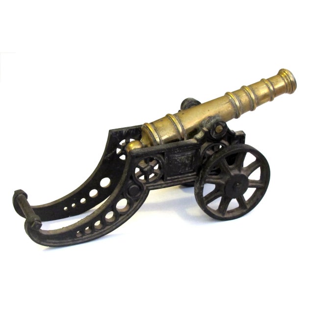 with solid brass tilting barrel resting on a heavy weight carriage with working wheels; finely and realistically decorated