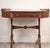An early 19th-century English Regency-period game/writing table. Burled amboyna wood inlaid with satinwood ebony and...
