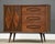 A mid century modern walnut six drawer dresser chest with a sliding door, burl details and long canted legs....