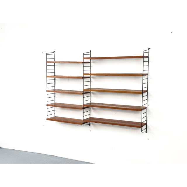 Original String shelving system, the classic from Sweden. Consisting of three black ladders (18 cm deep, 101 cm high) and...