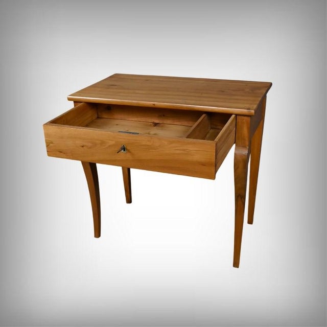 An elegant walnut console table, typical of the Restoration period, showcasing the clean, refined lines characteristic of...