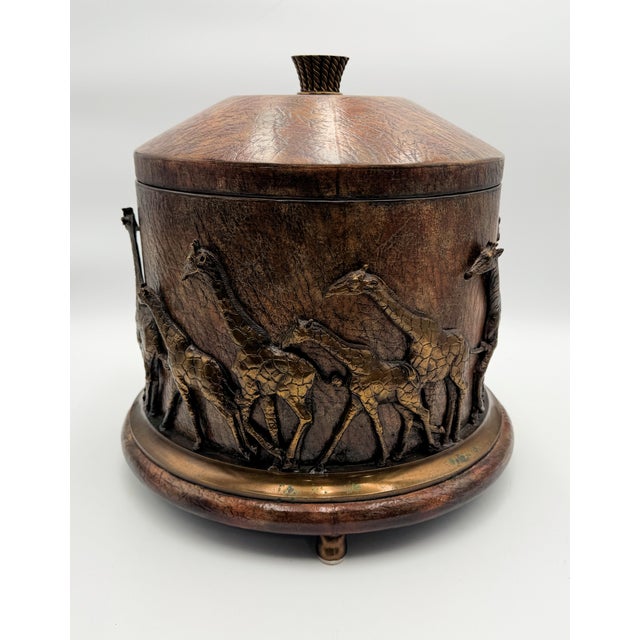 Vintage Maitland-Smith safari-themed lidded canister. It features a textured leather-like finish on the cylindrical body...