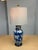 Design Plus Gallery presents a Blue with White Flower Table Lamp. The body of the lamp is vase like and porcelain with a...