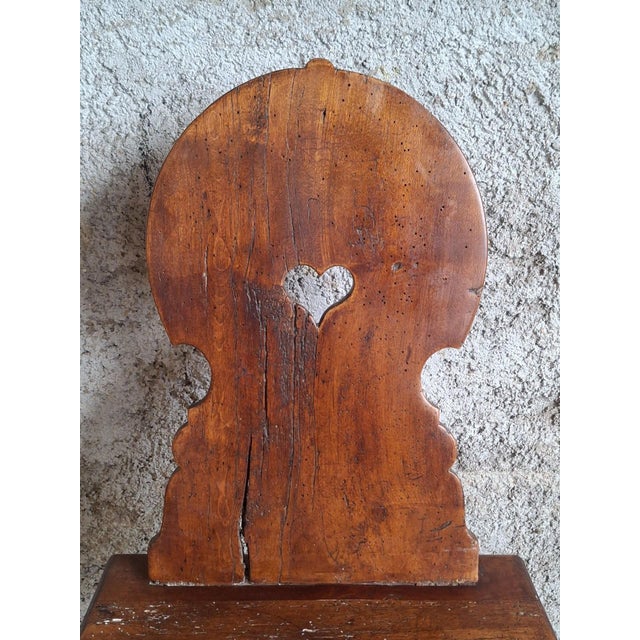 An authentic Alpine peasant chair made of solid wood, dating from the 18th century, a product of traditional rural...