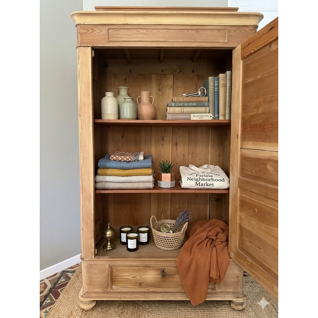 This authentic "Bonnetière" (single-door armoire) is a quintessential example of French provincial craftsmanship from the...