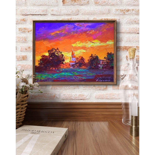 The painting titled ""Evening"" captures a stunning sunset over a quiet townscape, using rich, warm tones to convey the...