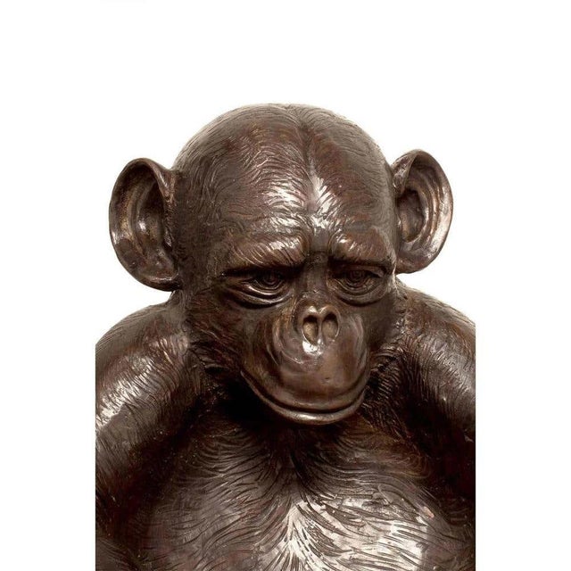 A cast bronze sculpture of a Charlie the Monkey with his arms forming a bowl. This lost wax cast bronze monkey is part of...