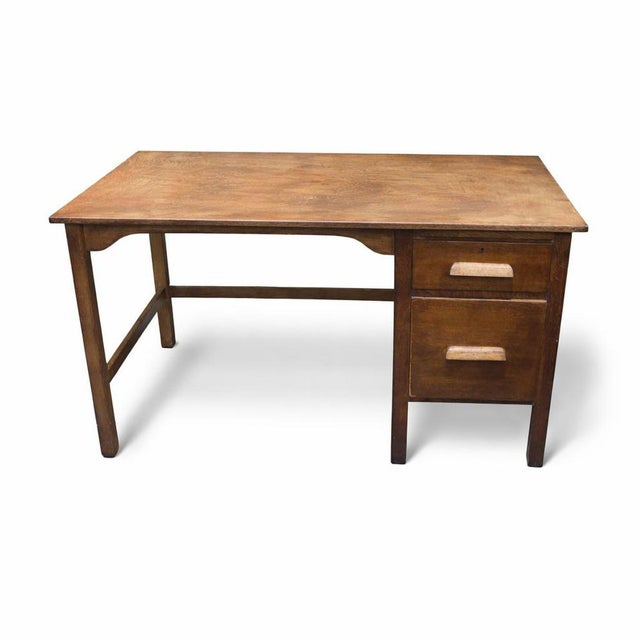 A characterful vintage oak school desk, crafted from solid wood and rich with authentic patina developed over decades of...