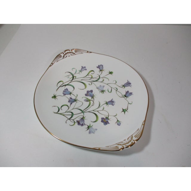 This serving dish with handles was made in England by the Spode Co. It is made of fine bone china, decorated with sprays...