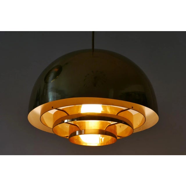 Elegant Mid-Century Modern brass pendant lamp or hanging light 'Dome'. Manufactured by Vereinigte Werkstätten Munich,...