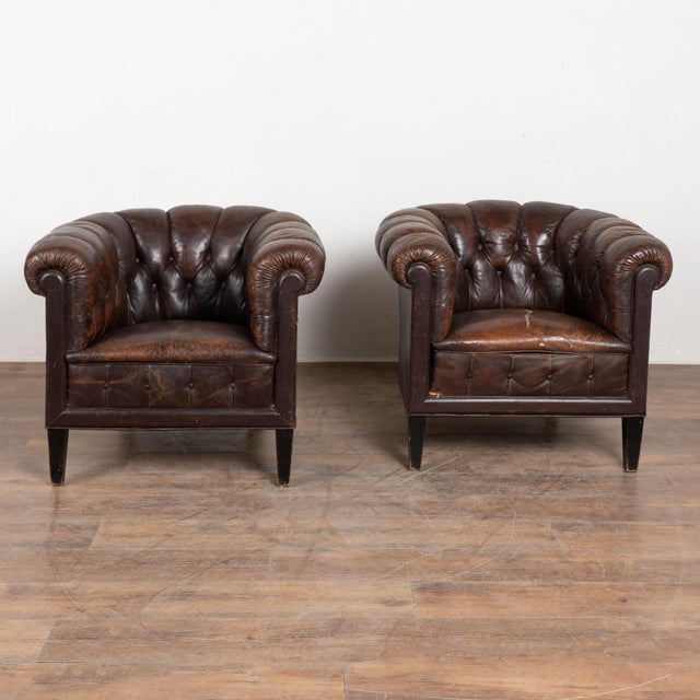 Pair of vintage brown leather club or tub chairs from Denmark. Upholstered in dark vintage brown leather, the chairs...