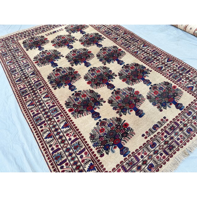 This graceful rug features the classical vase design: rows of stylized urns brimming with flowering bouquets in deep navy...