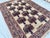 This graceful rug features the classical vase design: rows of stylized urns brimming with flowering bouquets in deep navy...