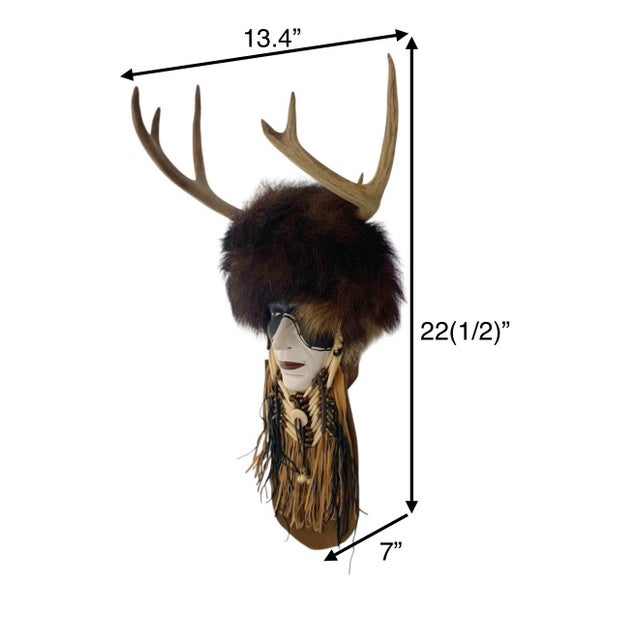 The Vintage Southwestern Plaster Shaman Mask with Real Deer Antlers and Fur is a unique and eye-catching wall hanging that...
