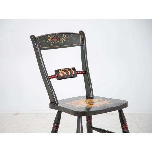 This antique side chair painted in green is a celebration of Christmas. The back features a holly and berry design and the...
