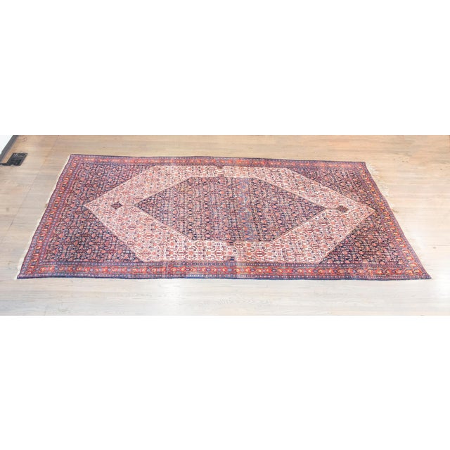 An exquisite example of early 20th-century Persian craftsmanship, this Senneh rug embodies the rich weaving heritage of...