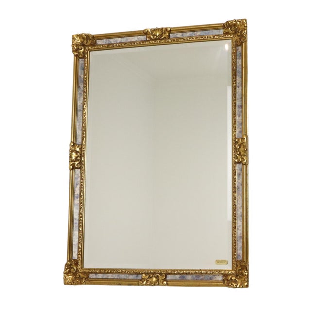 A fantastic gold-tone Deknudt mirror featuring marbled smoked-glass side panels and a central beveled mirror. Designed in...