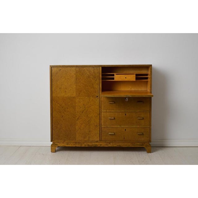 Swedish Grace cabinet or sideboard with a writing desk in the style of Axel Larsson. Made in dark-stained and polished...
