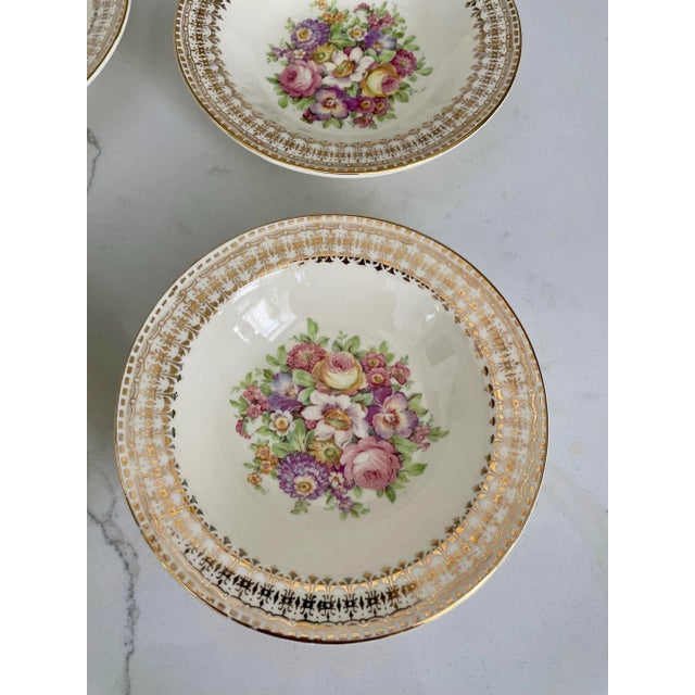 Offered is a lovely vintage set of dessert bowls by The Edwin M Knowles China Co. This set features a floral design with...
