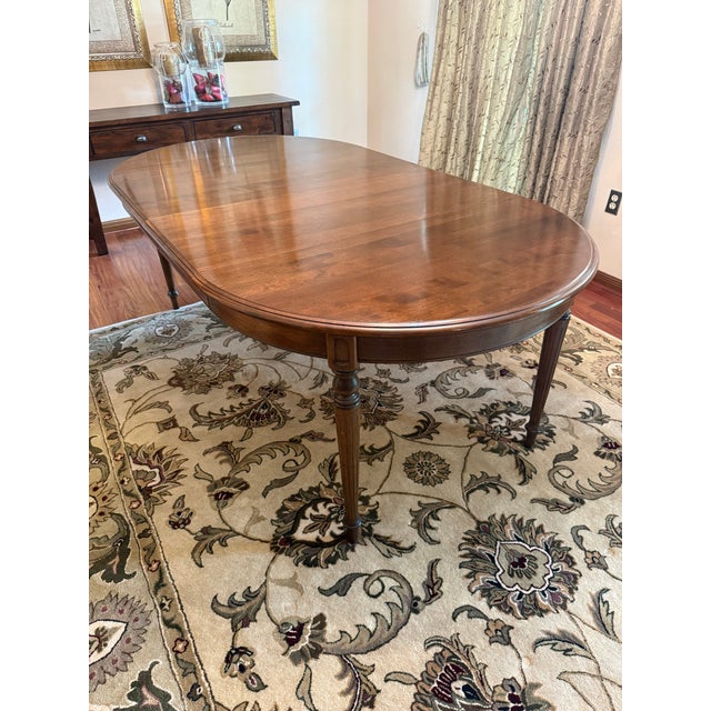 This is a vintage Ethan Allen Louis XVI style oval dining table. It has been kept in immaculate condition and comes with a...