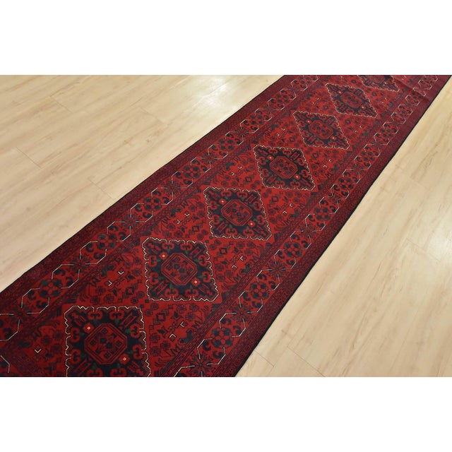 An authentic tribal Turkmen rug hand-knotted with fine wool and natural dyes. This nomadic rug features a row of geometric...