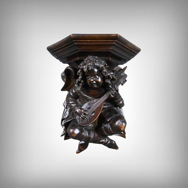 An elegant wall console in carved walnut, made at the end of the 19th century in the pure Renaissance style, featuring a...