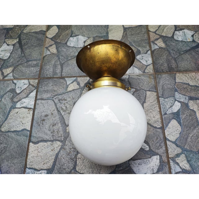 Art deco, brass ceiling lamp, dimensions: height 23.5 cm, diameter at top 14 cm. Up to 250V (Europe/UK Standard).The...