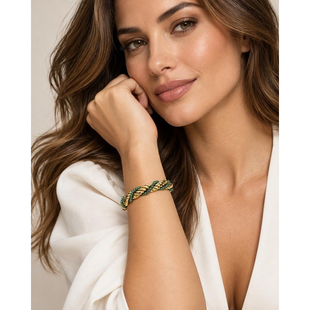 Elegant vintage 18k yellow gold rope bracelet accented with lush green emerald beads intricately wrapped around the...