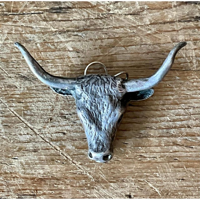 This striking vintage antiqued silver steer head pendant captures timeless Western charm, beautifully combining bold...