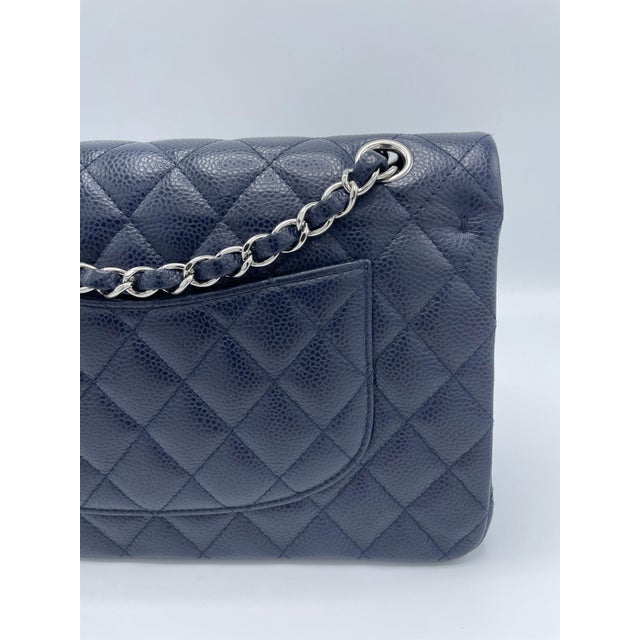 CHANEL Caviar Quilted Medium Double Flap Wallet in Navy. This classic flap bag is made of navy blue caviar leather that...