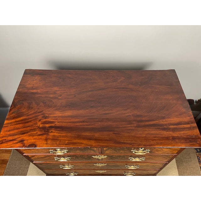 A striking English walnut chest of drawers from the first quarter of the 18th century (c. 1700–1725), retaining a...
