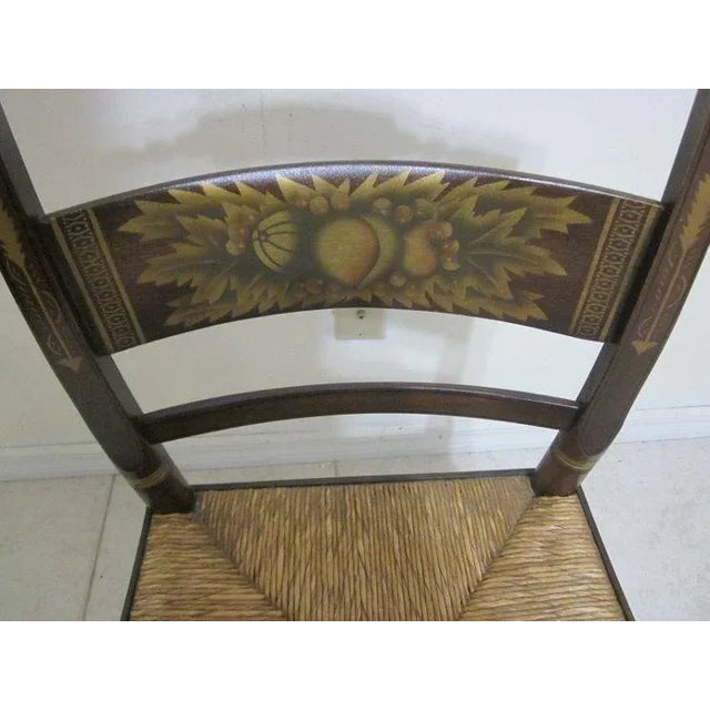 This antique side chair is a true gem for collectors. With its Hitchcock style and black gold stenciled design, it's sure...