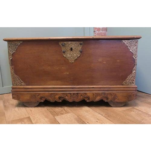 Carved Elm Coffer with Pierced Brass Decoration This large and heavy chest is set on wooden wheels and it has a carved...