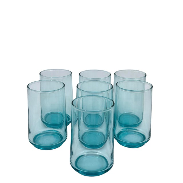 Vibrant turquoise juice glasses from the late 20th century. These are perfect for juice or a shot of health juices! Even...