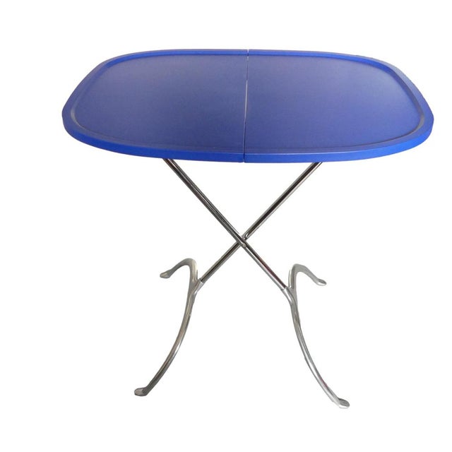 This minimalist coffee table/side table/folding table is a wonderful combination of aluminum and a blue technopolymer top....