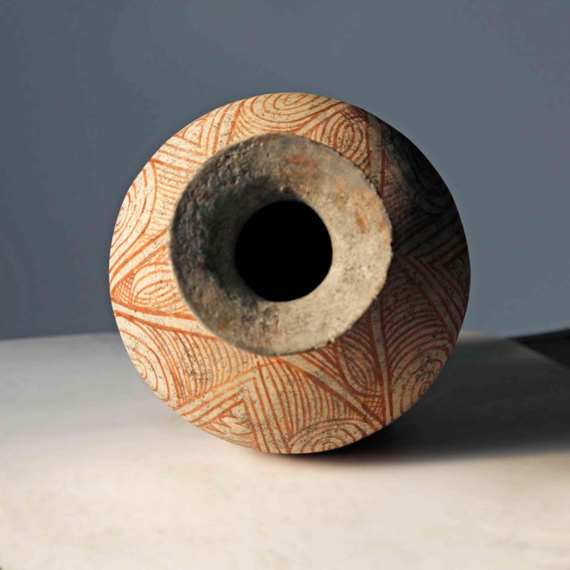 Antique Bai Chiang Thai bichrome pottery vessel with geometric designs incorporating spirals and scrolls.