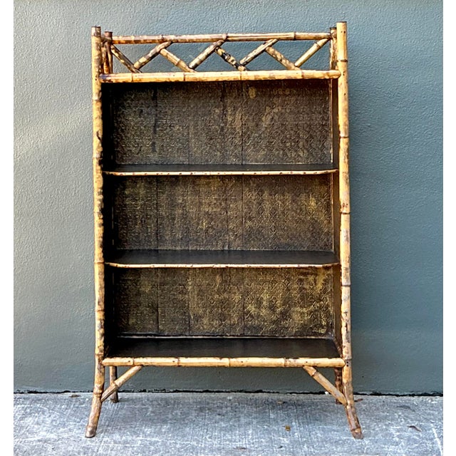 This striking vintage tortoise bamboo etagere is an exceptional example of Chinoiserie-inspired design, perfectly...