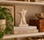 Striking 1980s ceramic sculpture depicting a stylized male nude torso, rendered in a soft ivory/blush glaze. The classical...