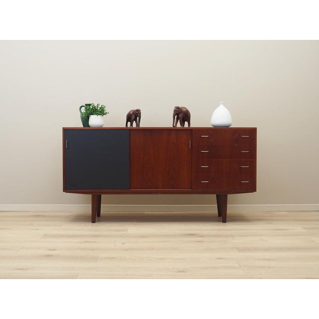 The dresser was made in the 1960s, Danish production. The structure is covered with teak veneer. Legs made of solid wood....