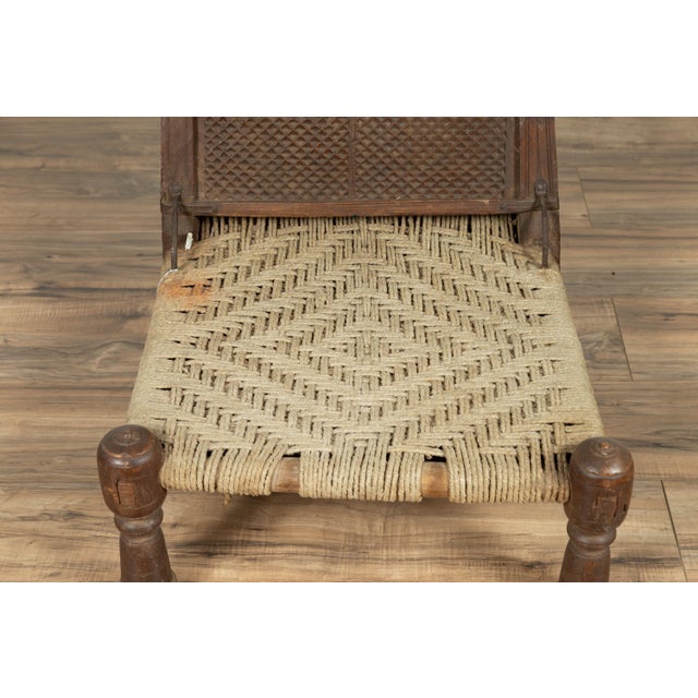 Early 20th Century Antique Indian Rustic Low Seat Wooden Chair With Carved Rosettes and Twine Seat For Sale - Image 5 of 14