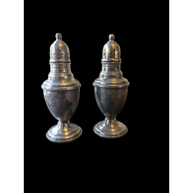 This beautiful pair of International Sterling Silver salt and pepper shakers features classic vintage styling and weighted...