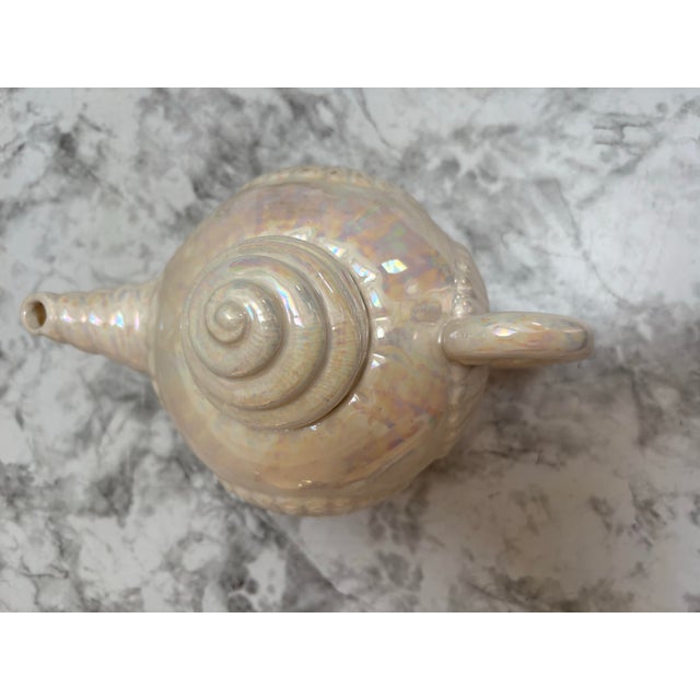 Vintage white opalescent ceramic seashell design teapot. Pearlescent glaze adds an elegant opal quality to the shell...