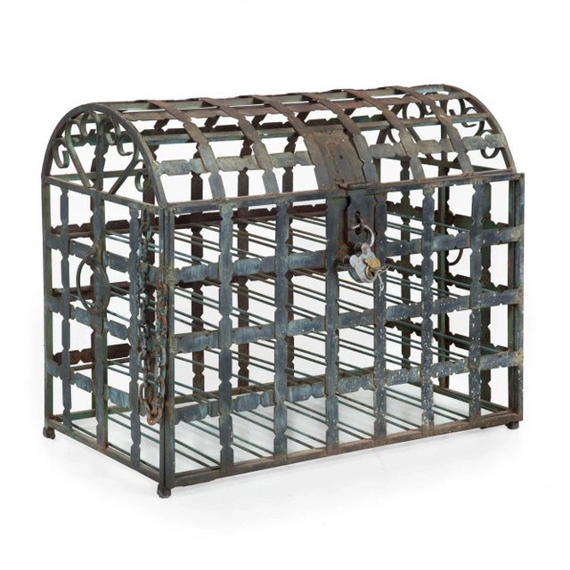 A fantastic and rather unusual wrought-iron wine storage rack styled as a domed chest, it features wide shaped straps...