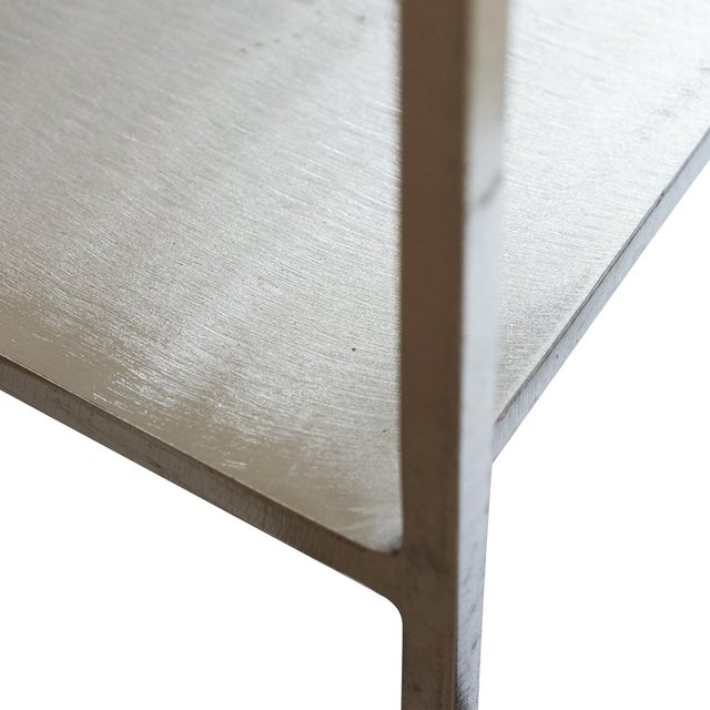 Glamorous yet Minimalist end table sourced from Belgium. It features solid white marble set atop a stunning bright steel...