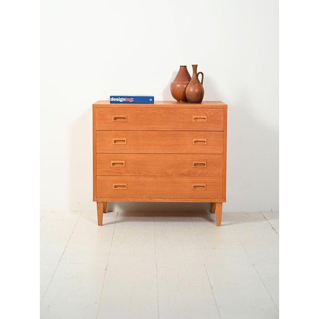 Swedish oak chest of drawers from the 1960s by String Design AB with carved handles and original label. Swedish oak chest...